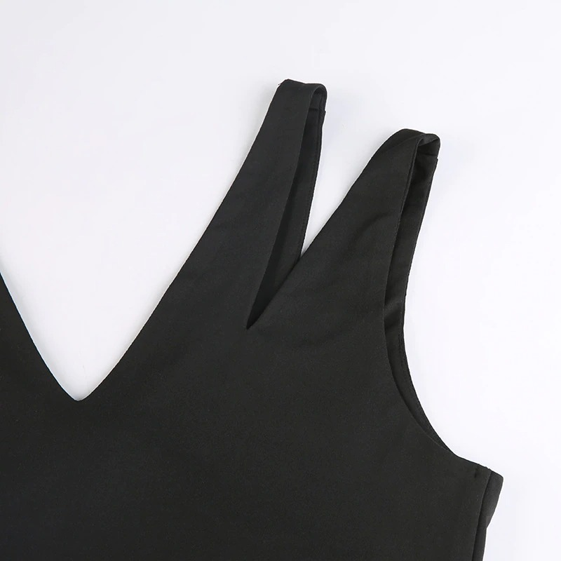 Close-up of a black goth cut-out crop top showcasing stylish straps and sleek design for a chic punk look.