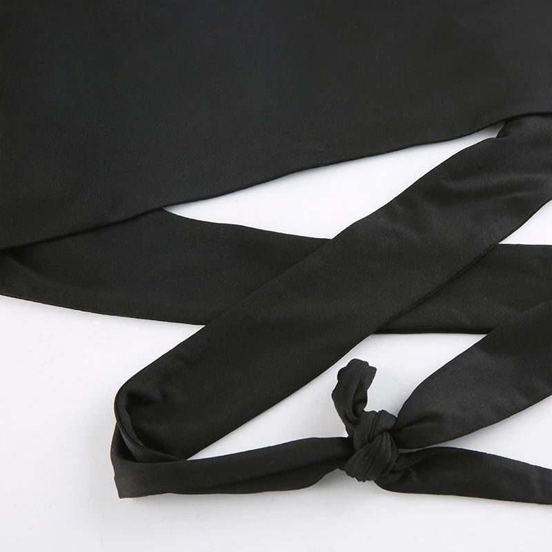 Close-up of black goth crop top showing stylish cut-out and tied straps for a chic punk look.