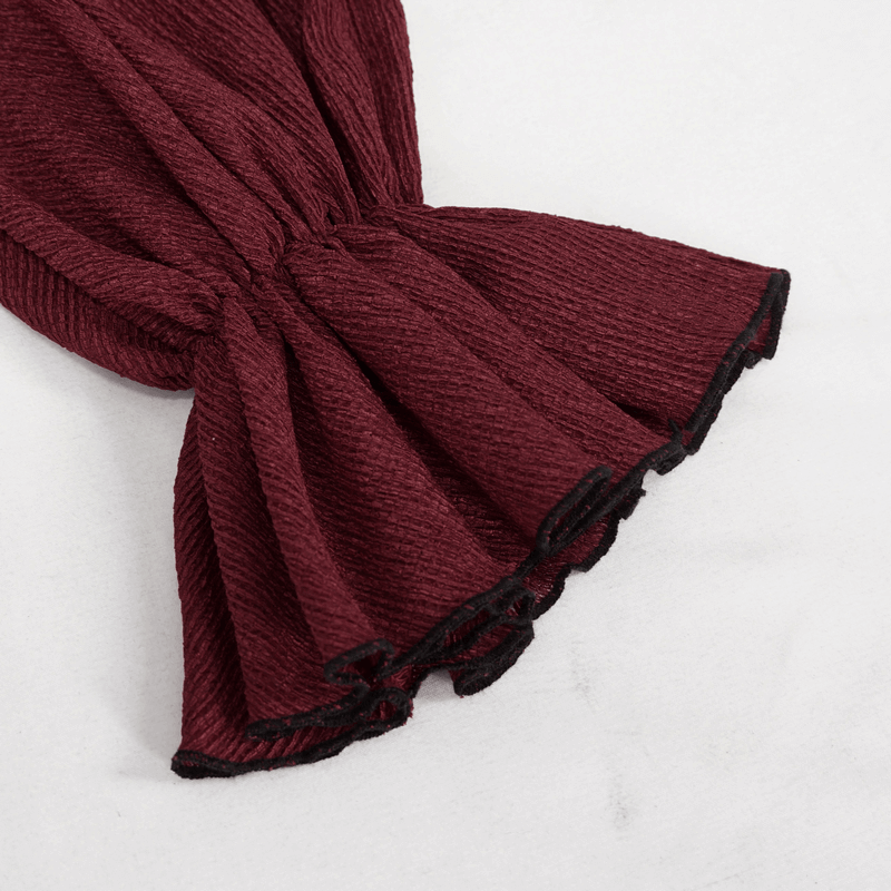 Close-up of flare sleeve detail on a wine red gothic blouse with black trim, showcasing stylish fabric texture.