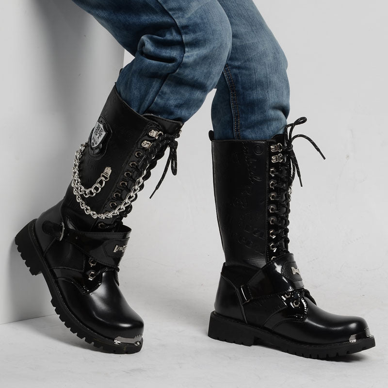 Gothic army boots with metal chains and badges, perfect for rock festivals and rave outfits, styled with denim.
