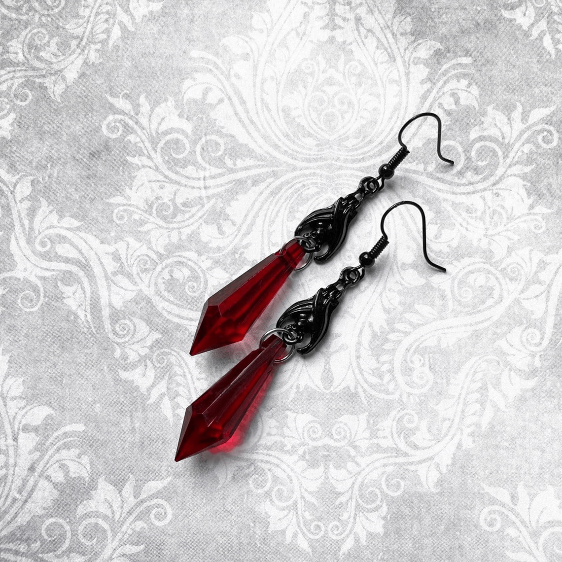 Gothic bat earrings with striking red teardrop beads, perfect alternative jewelry for a stylish look.