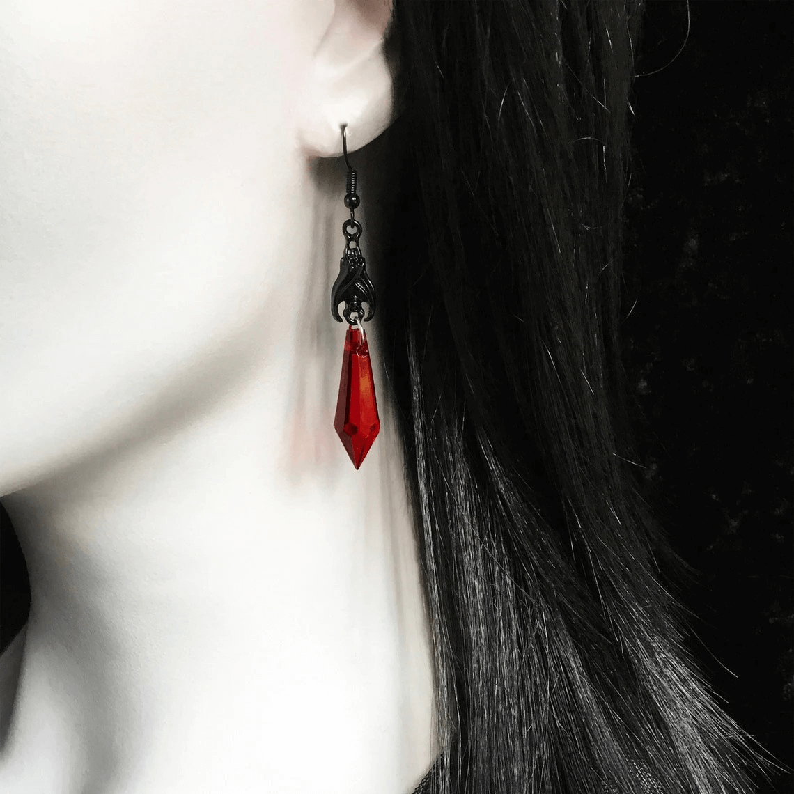 Gothic bat earrings with red teardrop beads, perfect alternative jewelry for bold female fashion.