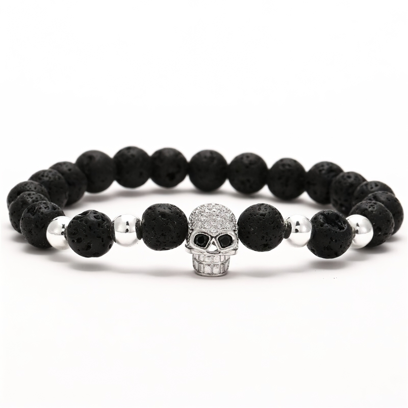 Gothic unisex bracelet featuring dark beads and a sparkling skull head for a rock style accessory.