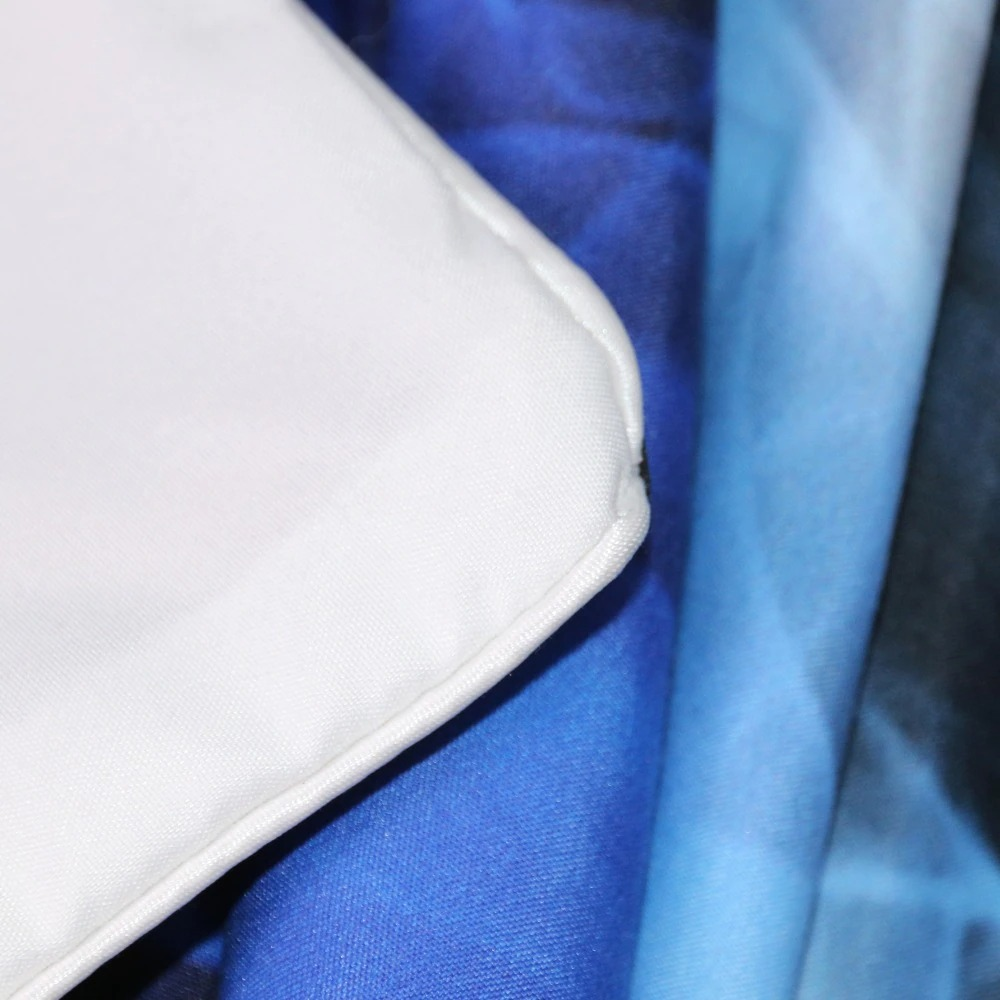 Close-up of gothic bedclothes set with vibrant blue prints and white pillowcase, perfect for trendy home decor.