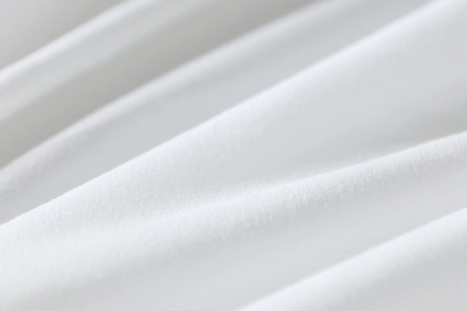 Close-up of soft white fabric texture, perfect for bedding and home decor.