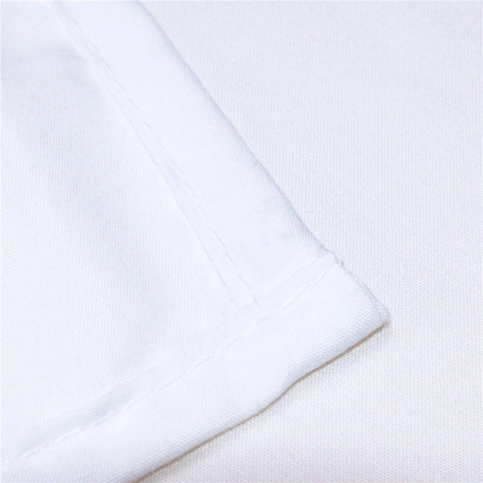 Close-up of white fabric corner showcasing neat stitching details for quality bedding.