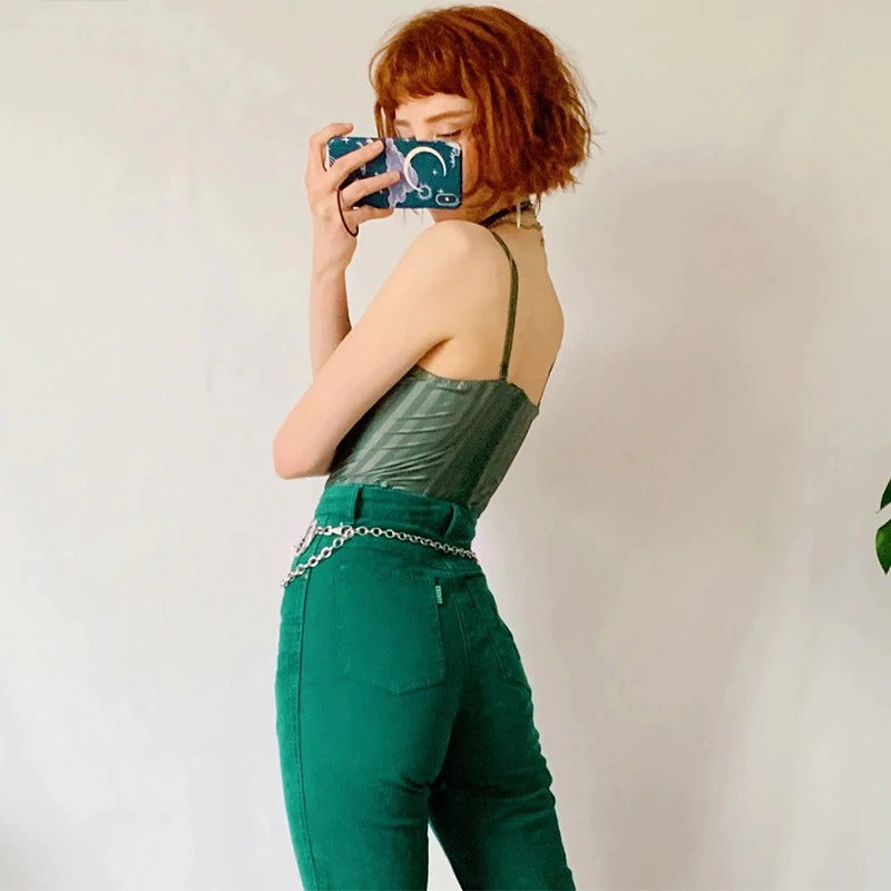 Model showcasing a Gothic metallic chain belt with moons, styled with a trendy green outfit.