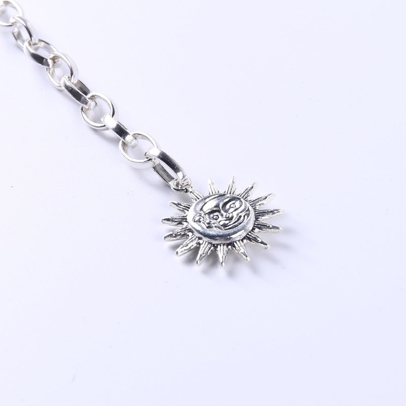 Gothic silver sun charm with spikes on a chain, perfect for adding a celestial touch to any accessory.