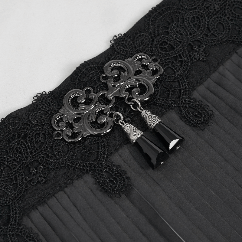 Close-up of elegant black lace with ornate silver embellishments and tassels, perfect for gothic fashion.