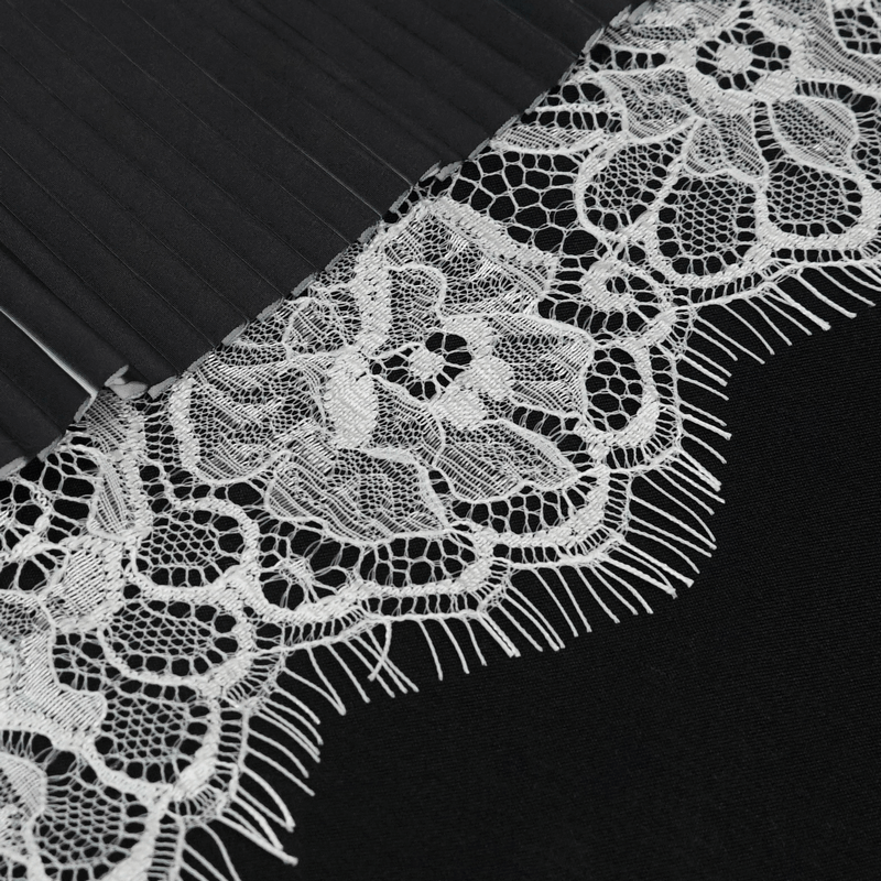 Close-up of gothic black and white lace with pleated texture, perfect for stylish fingerless gloves.