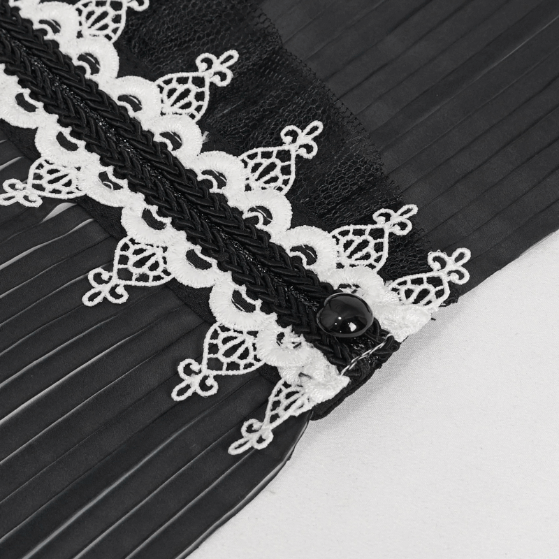 Close-up of black and white pleated lace collar featuring intricate beaded design and stylish button detail.