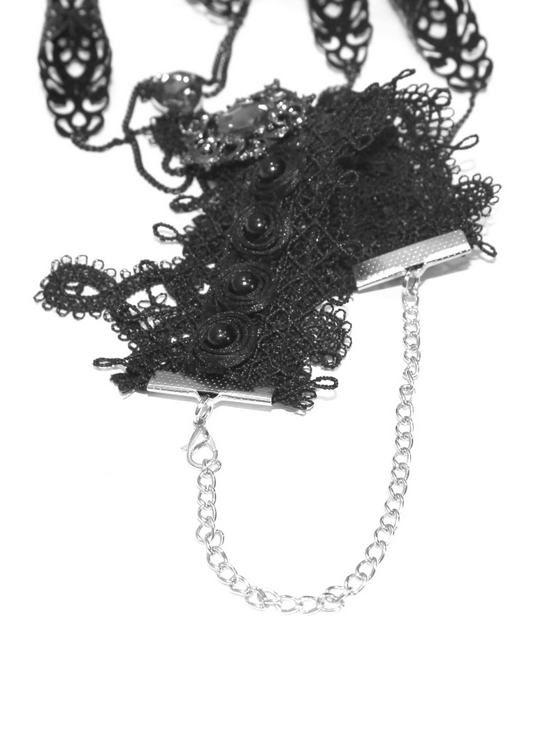 Gothic black bracelet with finger cover and chains, stylish lace accessory for women.