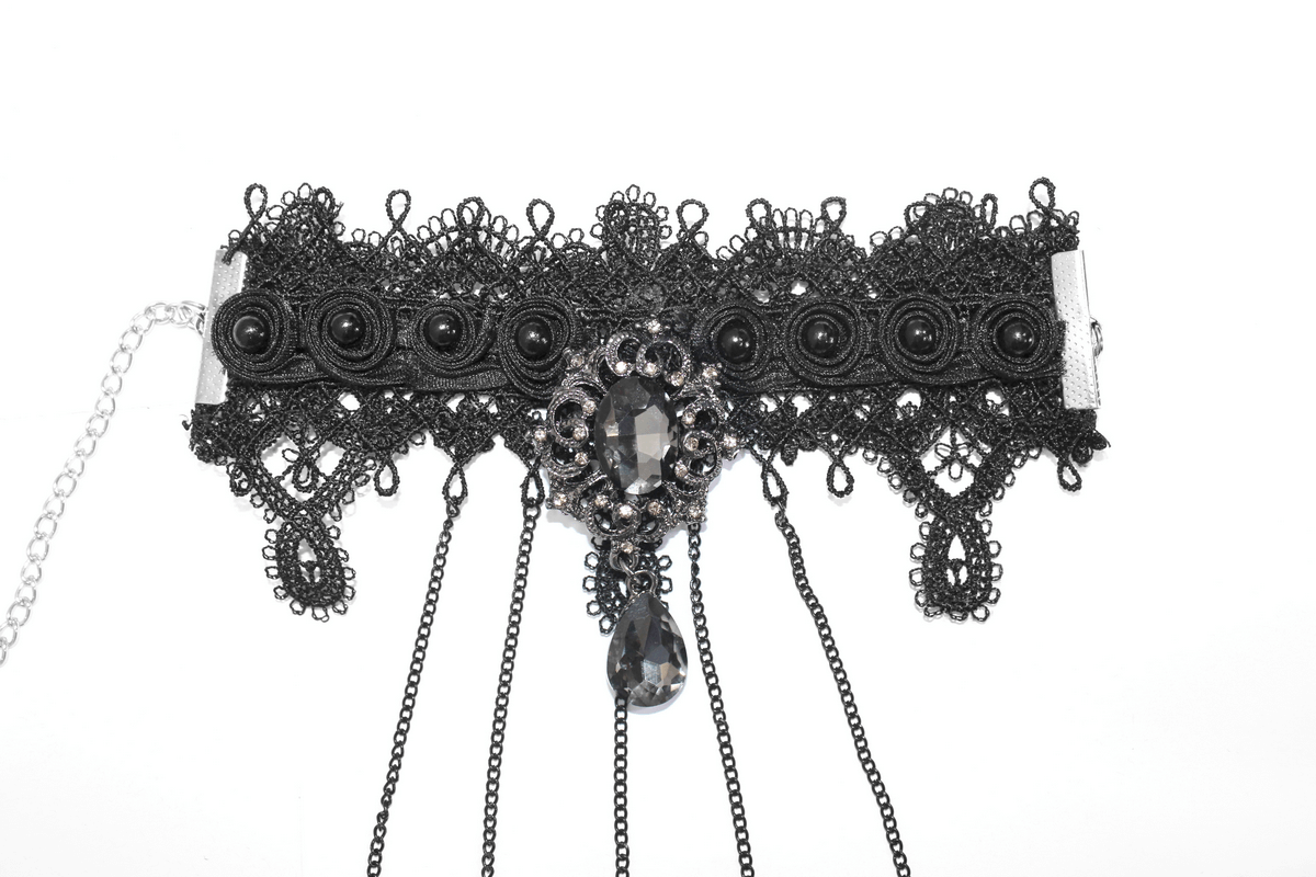 Gothic black bracelet with finger cover and chains, adorned with an elegant gem, perfect for any gothic outfit.