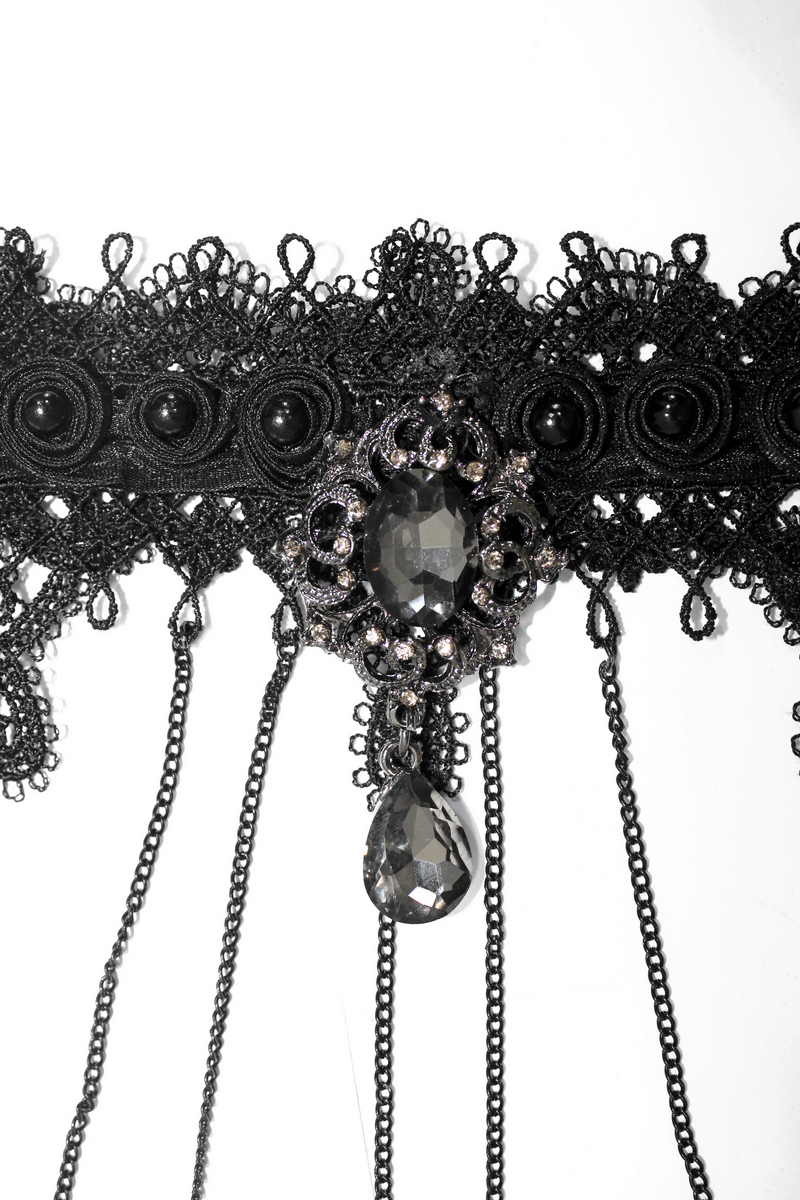 Stylish gothic black bracelet with finger cover, intricate lace, and chains for a unique fashion statement.