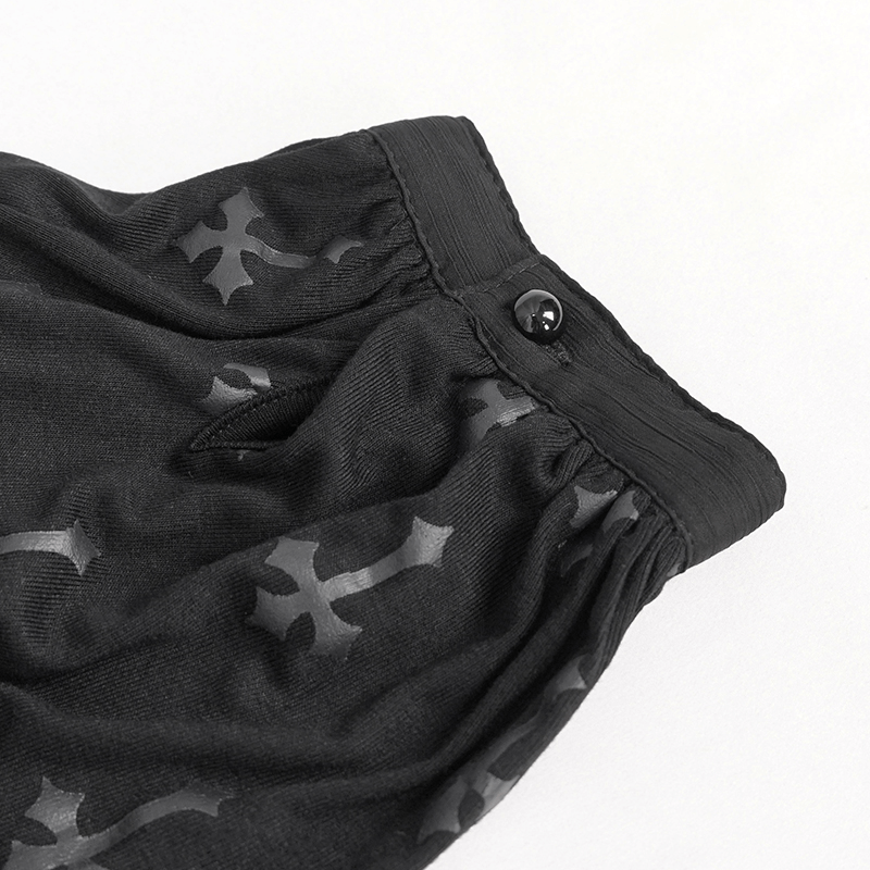 Close-up of gothic black cross pattern fabric with button detail on women's short sleeve blouse.