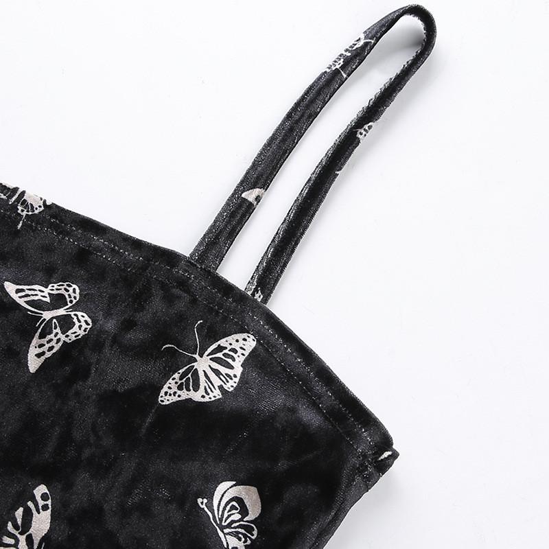 Close-up of black gothic dress straps adorned with butterfly patterns, showcasing backless and sleeveless design.