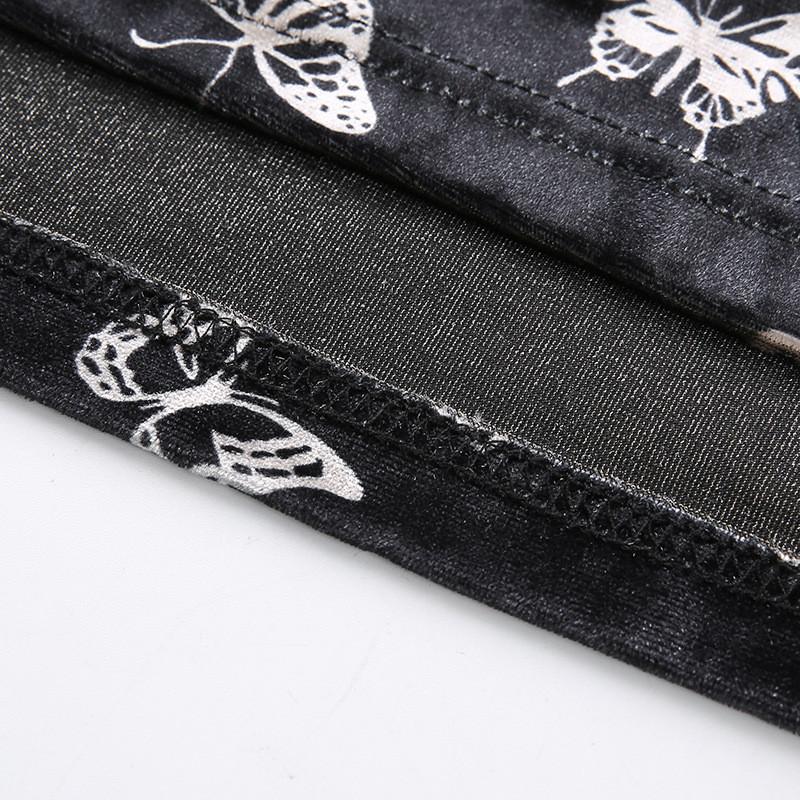 Close-up of the black fabric featuring butterfly prints on a gothic backless dress for women.