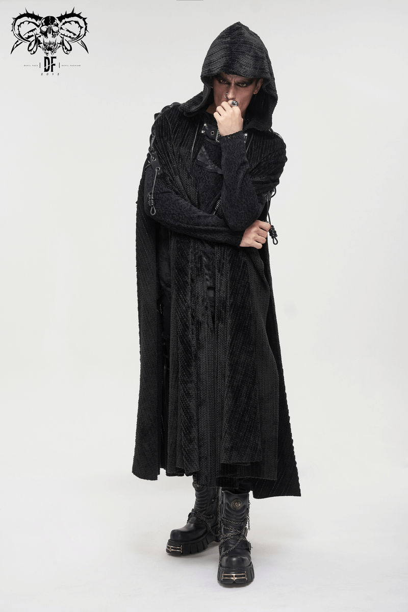 Man wearing a gothic black fleece hooded cape with buckle belt and fur collar, showcasing vintage style.