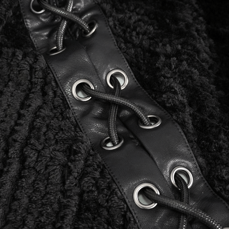 Close-up of black fleece fabric with leather lace-up detail and eyelets on a gothic cape.