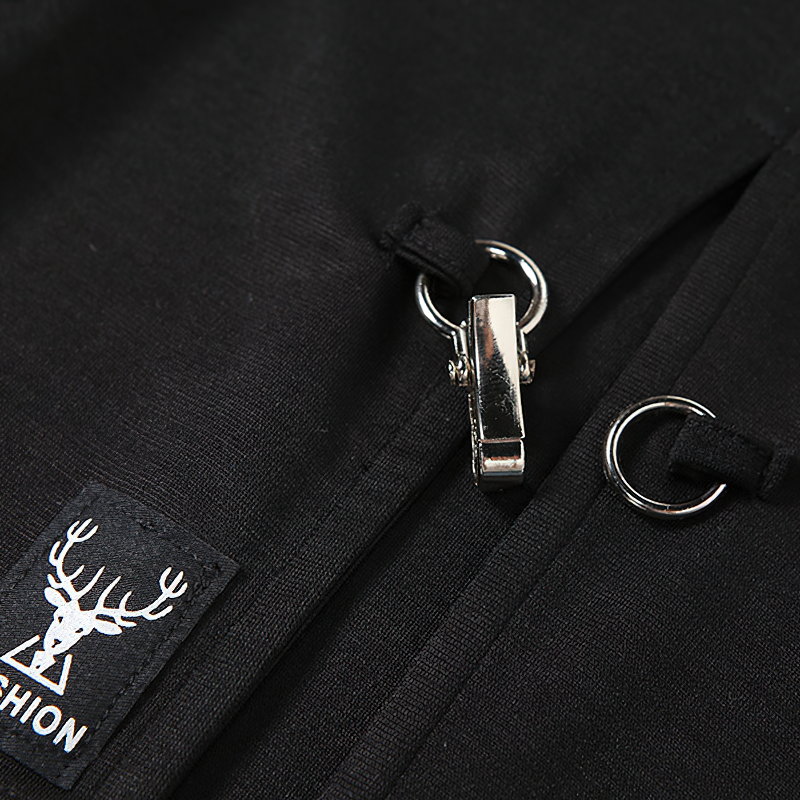 Close-up of black fabric with a zipper and metal accents, featuring a deer logo for fashion details.