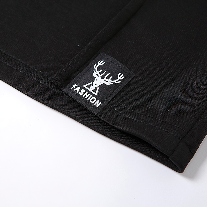 Close-up of a black fabric showing the label with a deer logo and the word 'FASHION'.
