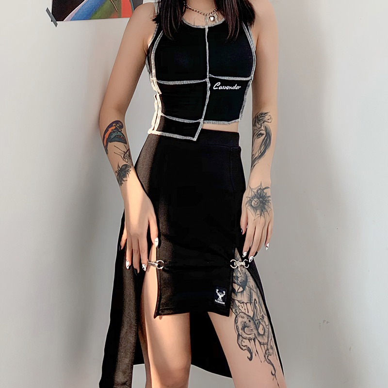 Gothic black knee-length skirt with high waist and hollow outs, styled with a unique crop top and edgy tattoos.
