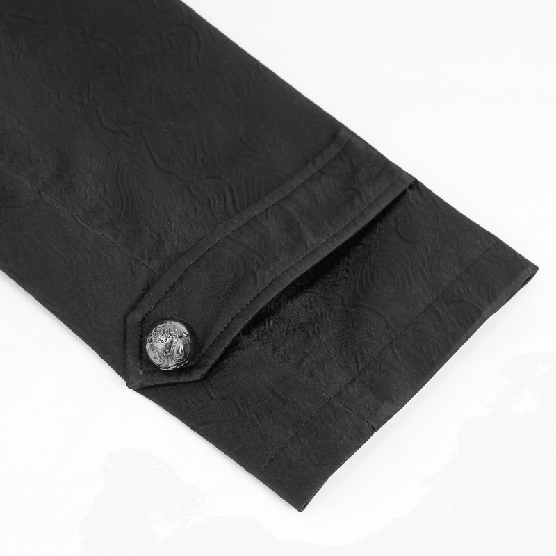 Close-up of the sleeve of a gothic black leather coat with a patterned button for punk style.