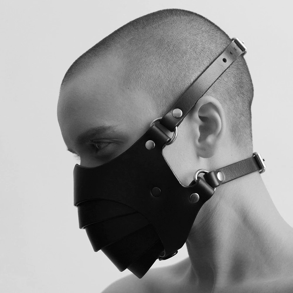 Stylish black gothic mask on a model, featuring adjustable straps for unisex cosplay or steampunk fashion.