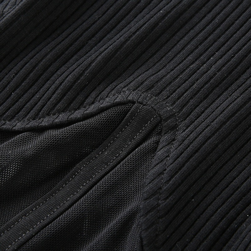 Close-up of a gothic black mesh top with ribbed texture, showcasing fabric details and stitching design.