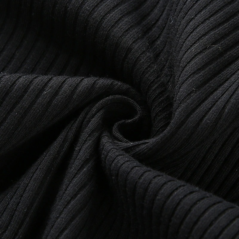 Close-up of soft black ribbed fabric, perfect for a gothic black mesh top or punk aesthetic clothing.
