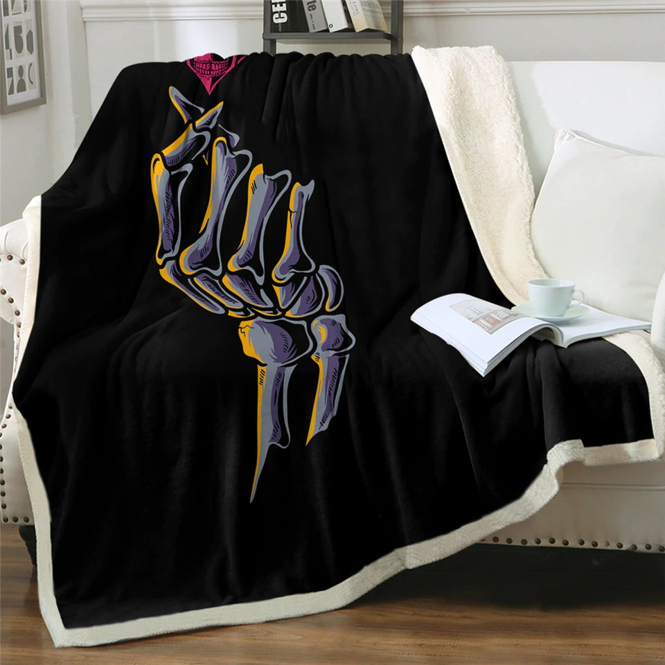 Gothic black plush blanket with skeleton print on a cozy couch, perfect for adding mystic vibes to your home.