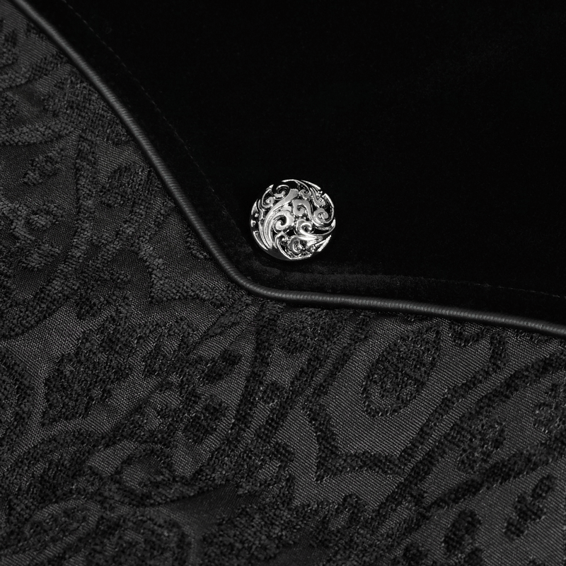Close-up of a silver ornate button on a gothic black floral embroidered coat fabric.
