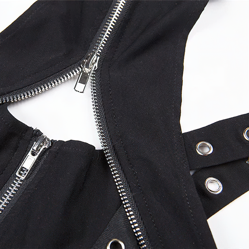 Close-up of a black gothic crop top featuring zippers and silver rivets for a trendy vintage look.