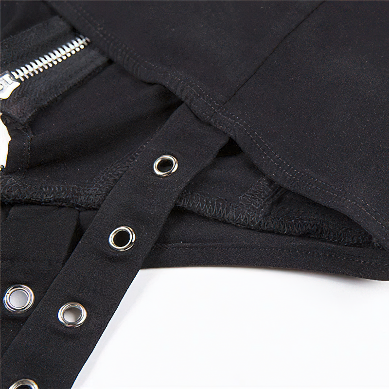 Close-up of a gothic black crop top featuring silver rivets and a zip detail, showcasing trendy women's fashion.