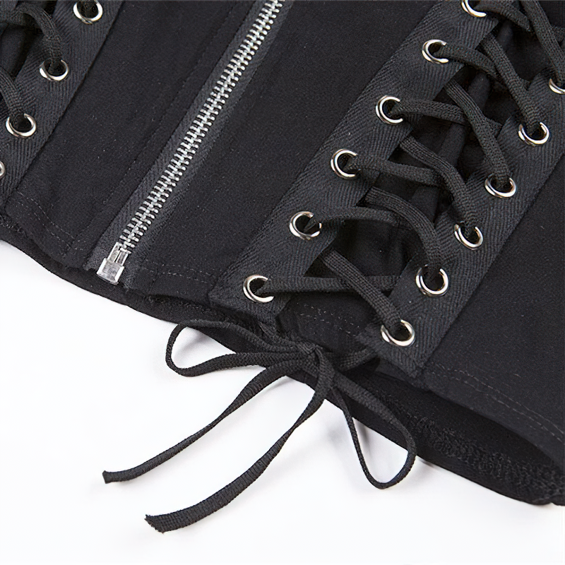 Detail of a gothic black crop top featuring silver rivets and corset-style lacing, perfect for trendy women's fashion.
