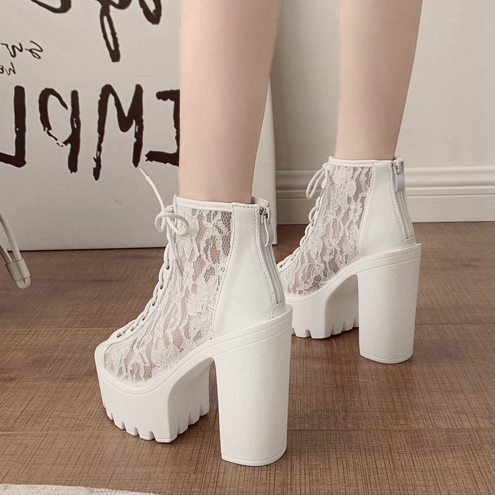 Gothic white lace platform ankle boots with thick square heels for a stylish alternative rock look.