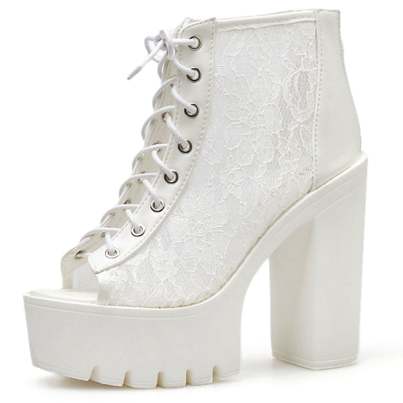 Gothic white platform sandals with lace details and thick square heels, perfect for alternative rock style outfits.