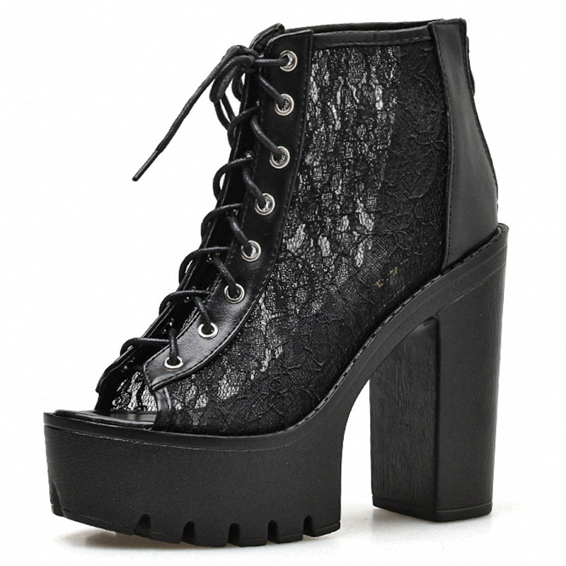 Black lace-up platform sandals with thick square heels for a Gothic rock style look.