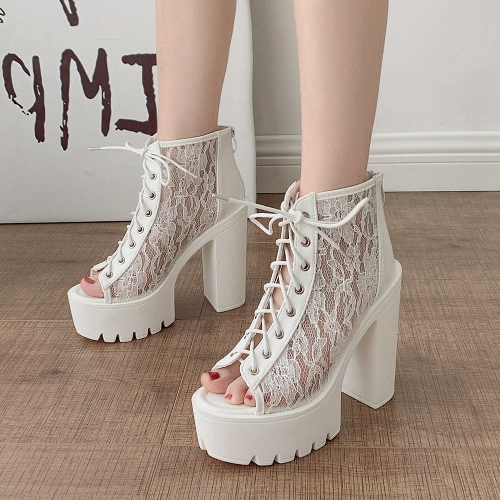 White lace open-toe high heel sandals with thick platform soles for a stylish and elegant look.