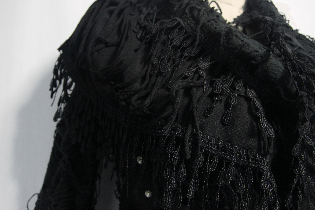 Close-up of a gothic black coat with intricate fringe details, showcasing its steampunk style and stylish design.
