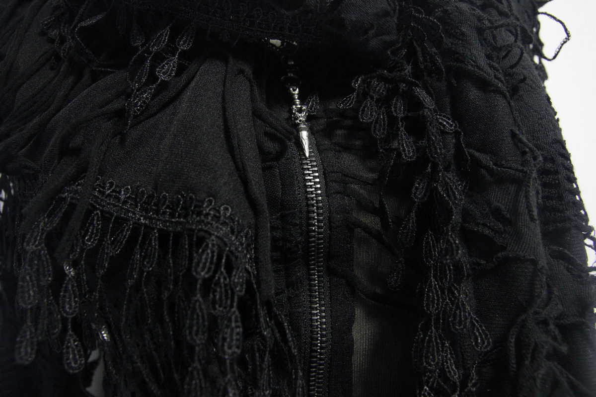Close-up of the intricate fringe and zipper details on a black gothic women's coat with hood.