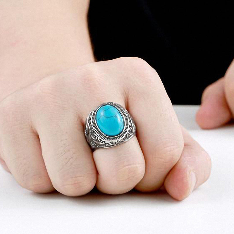 Gothic blue and black stone ring on hand, crafted in stainless steel, perfect unisex fashion jewelry.