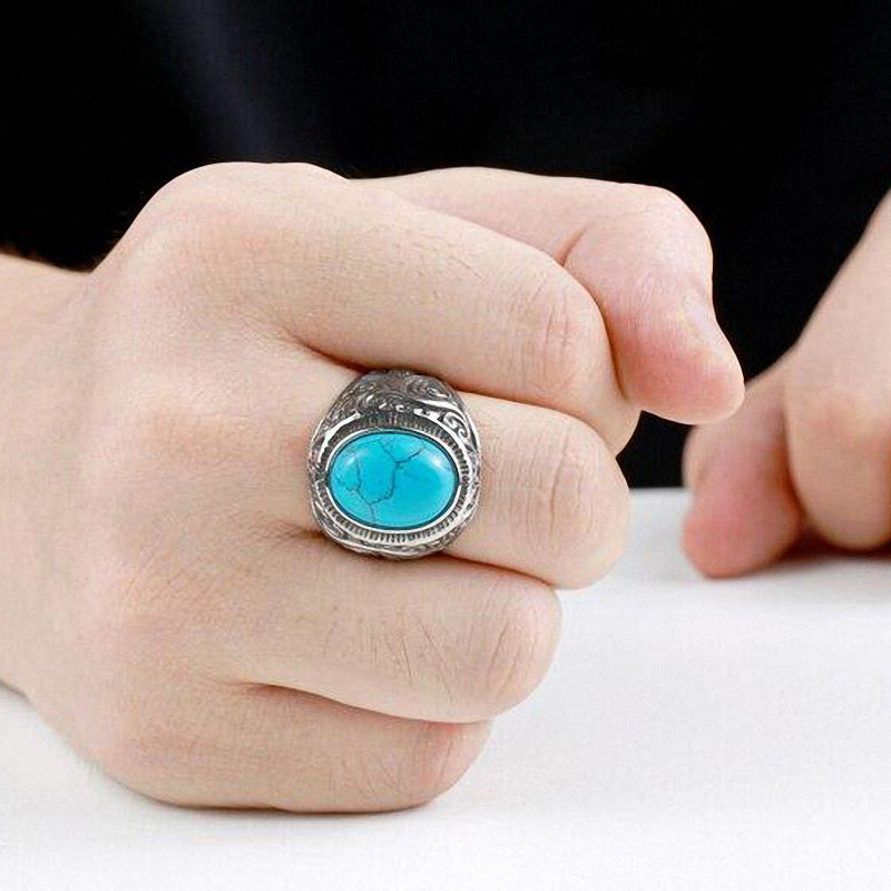 Stylish goth blue and black stone ring on a model's hand, showcasing unique stainless steel design and comfort.