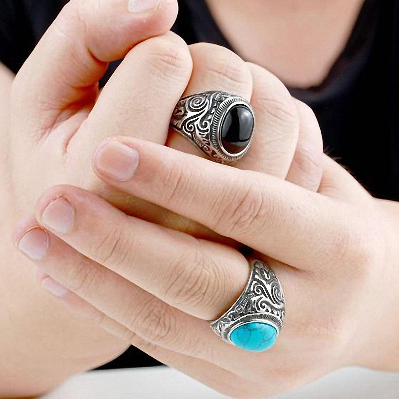 Gothic blue and black stone rings on hands showcasing intricate stainless steel designs for stylish fashion.