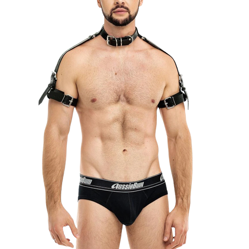Men's gothic faux leather body harness belt with silver fittings, showcasing punk style and bold erotic fashion.