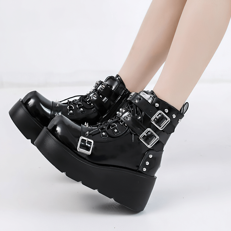 Stylish black platform ankle boots with spikes and buckles, perfect for a punk fashion statement.