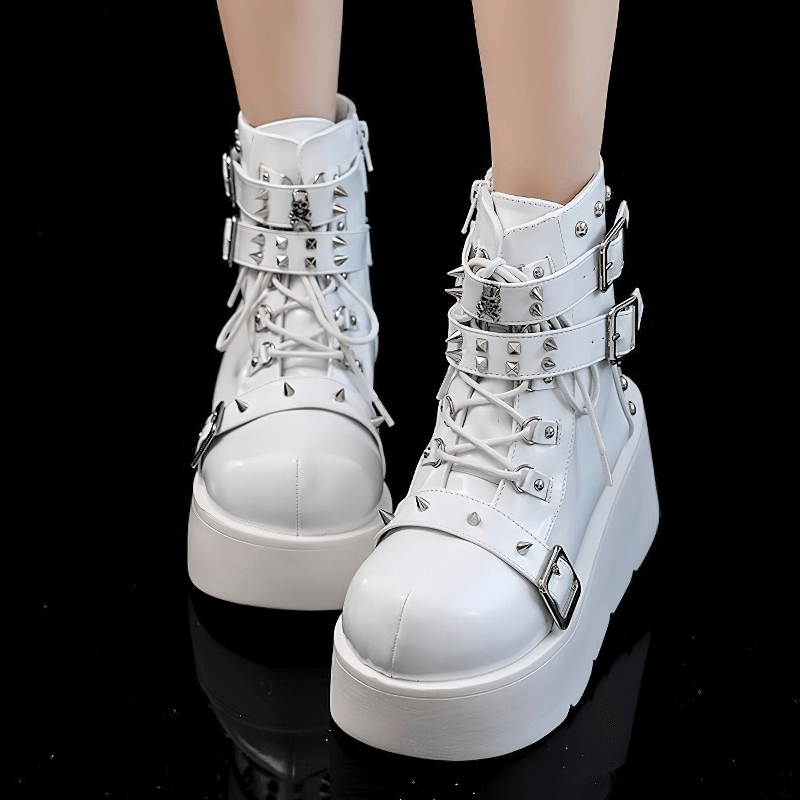 Gothic white platform ankle boots with spikes, rivets, and buckle detailing for a punk style.