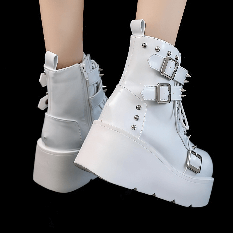 White Gothic platform ankle boots with spikes and rivets, featuring buckle straps for a punk style look.