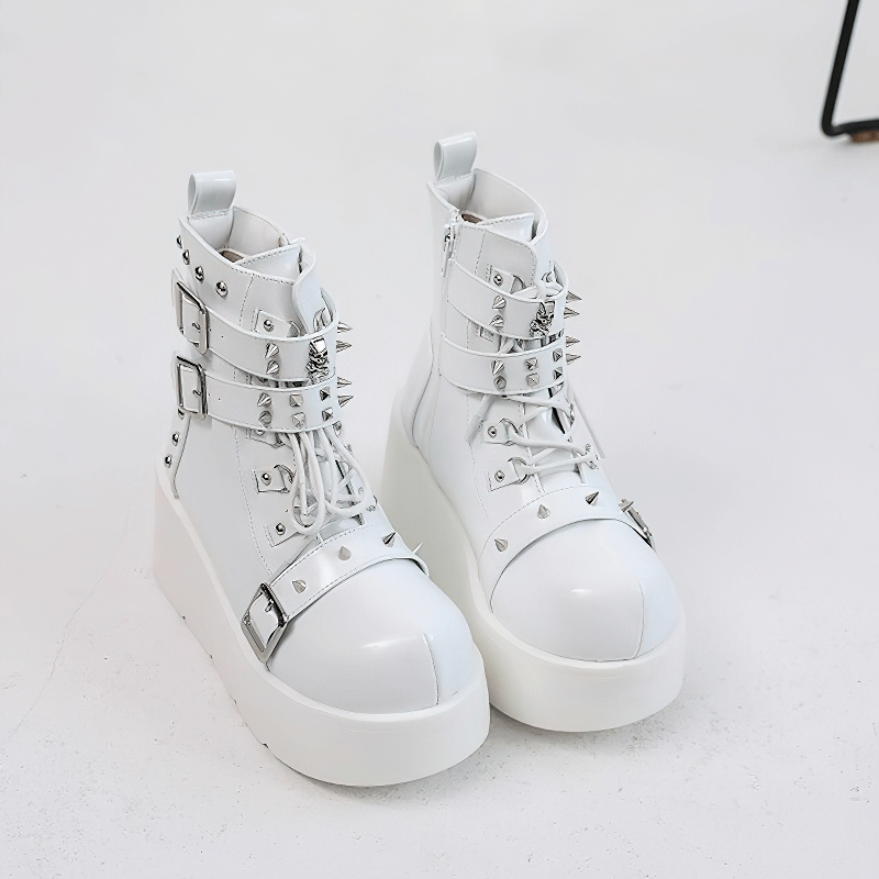 White gothic platform ankle boots with spikes and rivets for punk fashion lovers.