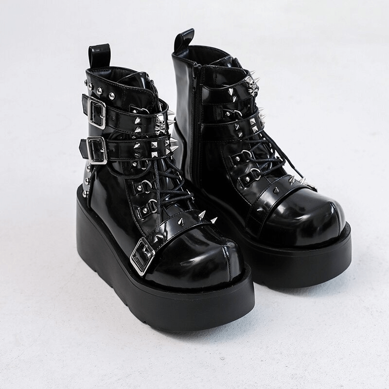 Gothic black platform ankle boots with spikes, rivets, and buckles for a punk rock style.